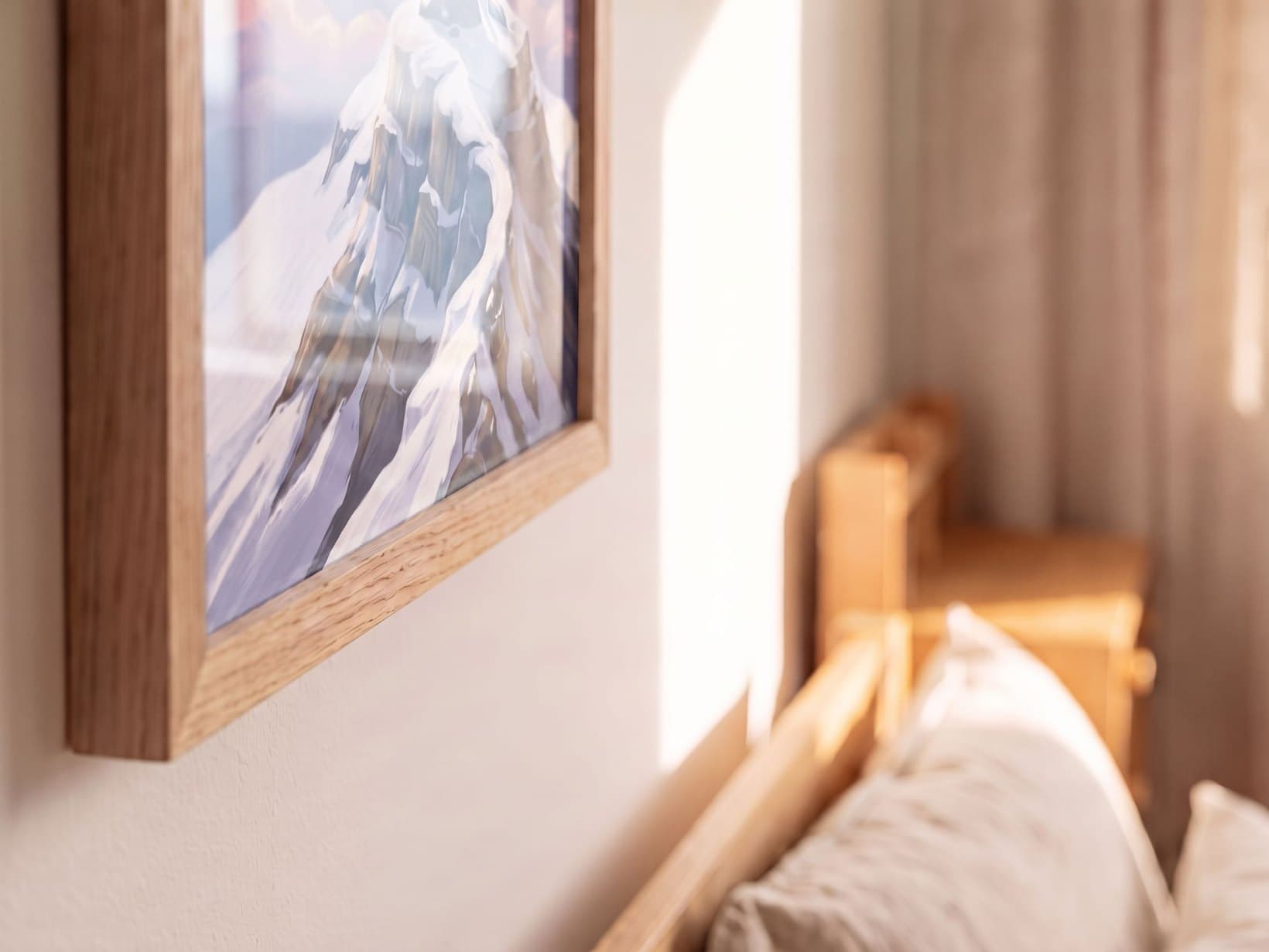 The framed piece on a bedroom wall, the morning room soft behind it